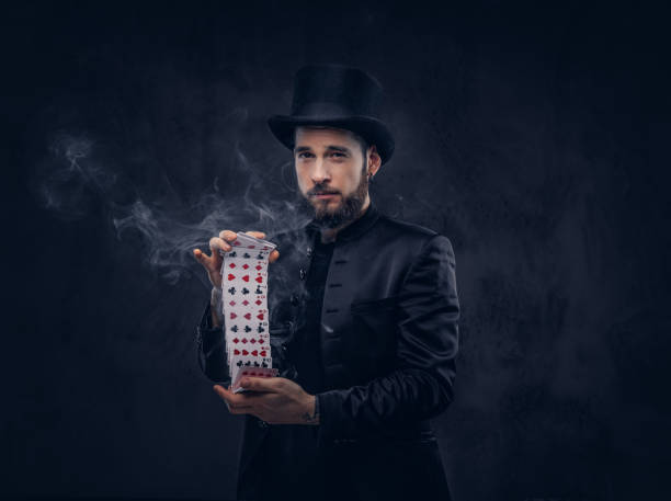 istock Magician showing trick with playing cards. 906854024