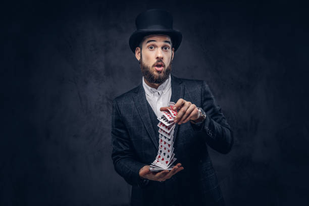 istock Magician showing trick with playing cards. 906854172