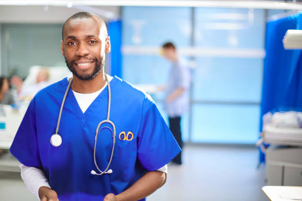 happy male doctor on the ward - nurse doctor scrubs male imagens e fotografias de stock