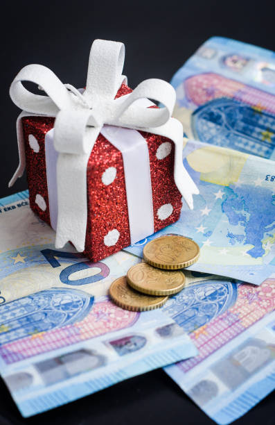 istock Red toy gift and euro on black 906854612