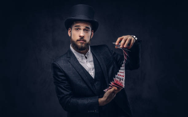 istock Magician showing trick with playing cards. 906854682