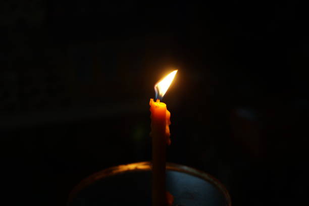 istock candle growing in the dark background 906854810