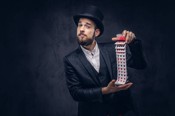 istock Magician showing trick with playing cards. 906854816