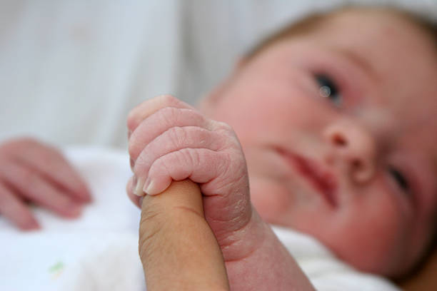 istock New Born Infant Holding Daddy Finger 90685656