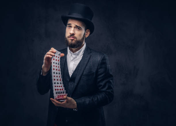 istock Magician showing trick with playing cards. 906857662