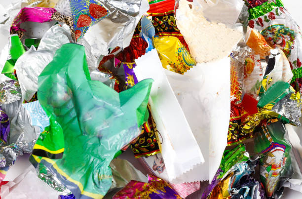 istock A bunch of candy wrappers on a white background. Closeup 906857926