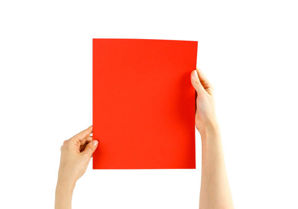 istock Hands holding a red paper on a white background. Closeup 906857978