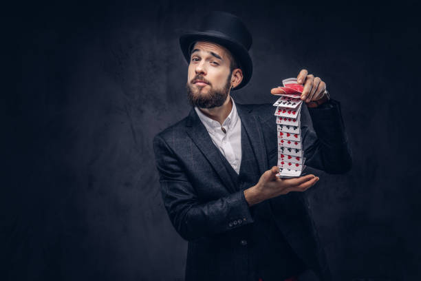 istock Magician showing trick with playing cards. 906858140