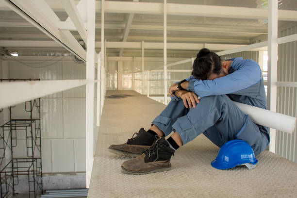 istock Young Asian engineers with blue helmet suffering stress fail to make mistakes in their work and business sit down on the floor 906858284