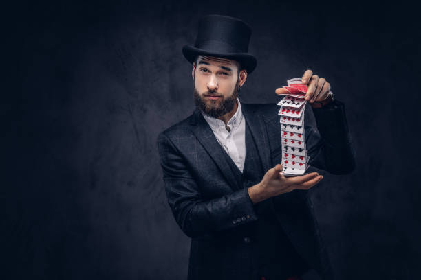istock Magician showing trick with playing cards. 906858760