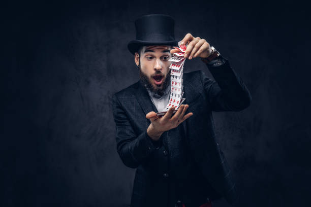 istock Magician showing trick with playing cards. 906861154