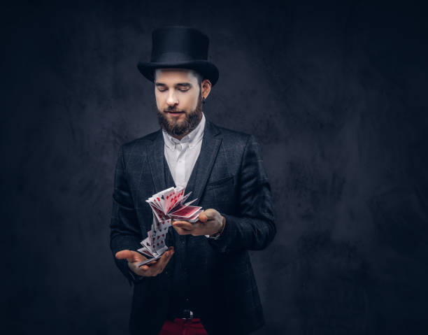 istock Magician showing trick with playing cards. 906861294