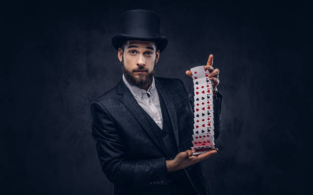 istock Magician showing trick with playing cards. 906861376
