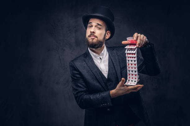 istock Magician showing trick with playing cards. 906861674
