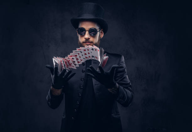 istock Magician showing trick with playing cards. 906861764