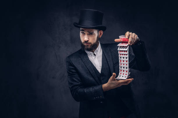istock Magician showing trick with playing cards. 906862796