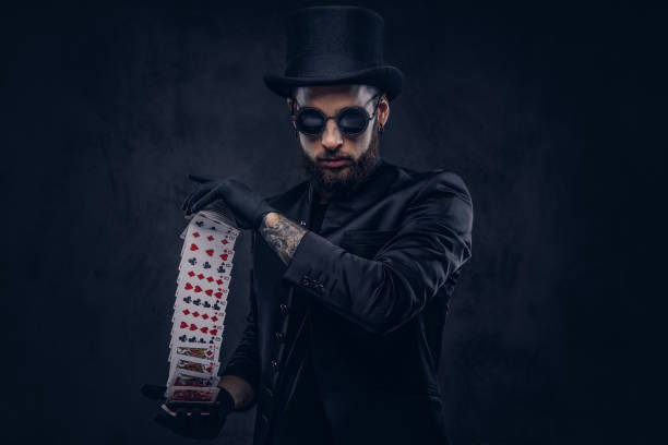 istock Magician showing trick with playing cards. 906862876