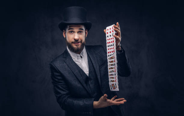istock Magician showing trick with playing cards. 906865128