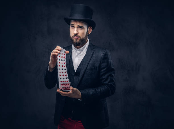istock Magician showing trick with playing cards. 906865278