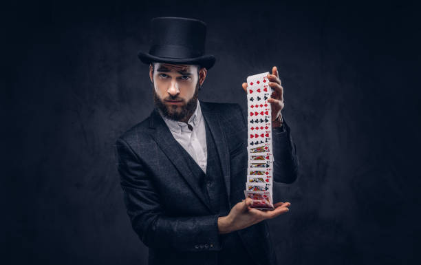 istock Magician showing trick with playing cards. 906865602