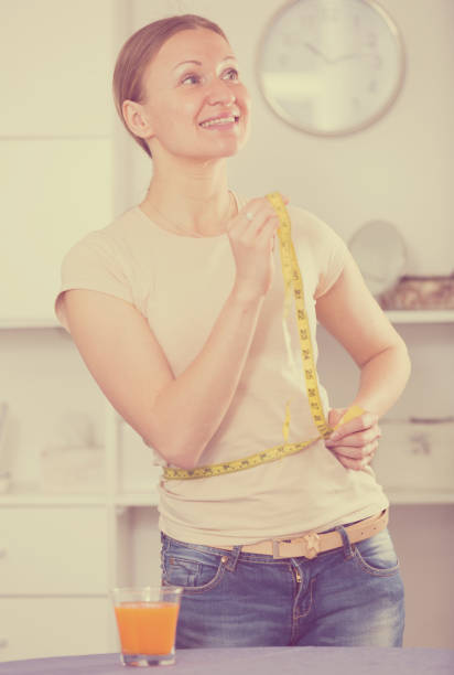 istock Woman controlling waistline 906865656