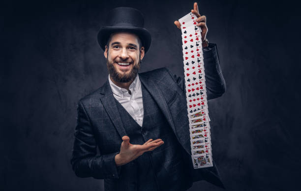 istock Magician showing trick with playing cards. 906865684