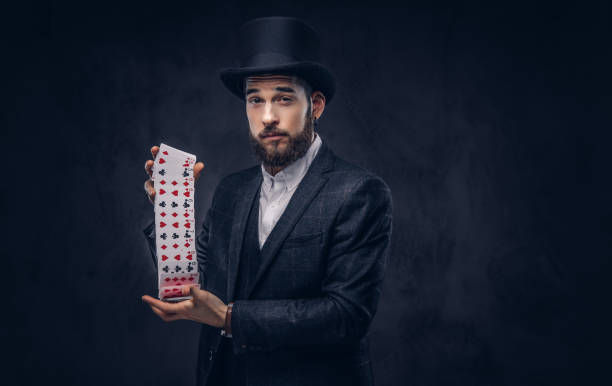 istock Magician showing trick with playing cards. 906866738