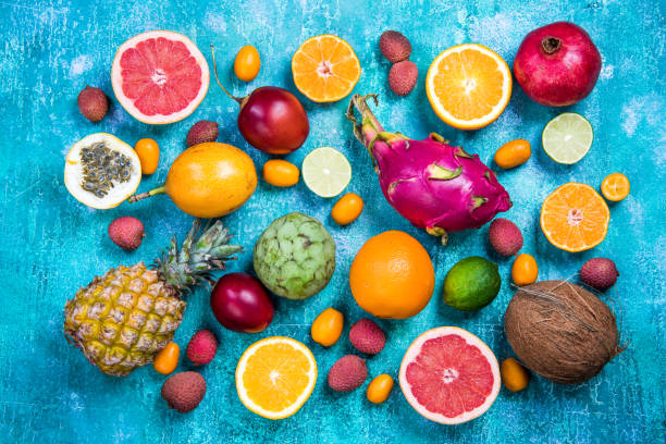 istock Exotic fruits on vibrant concrete slate,flat lay 906866860