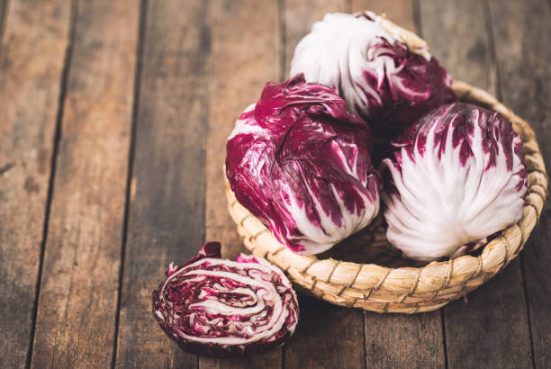 Red organic radicchio in the basket Red organic radicchio in the basket chicory stock pictures, royalty-free photos & images