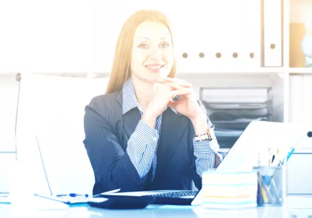 Photo of Cheerful businesswoman at workplace
