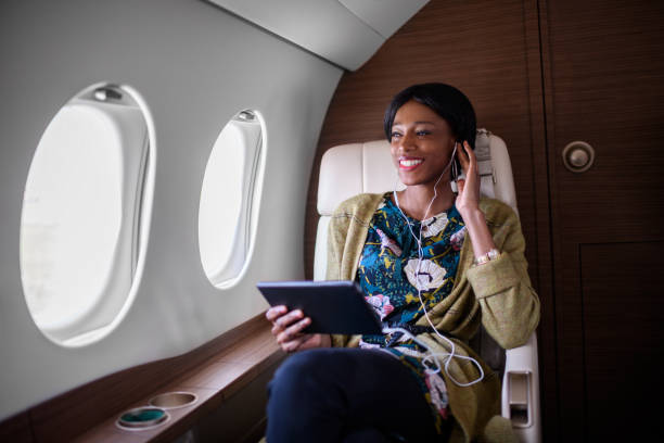 istock Woman in private jet airplane 906870010