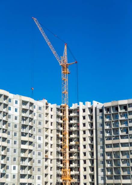istock Tall cranes and multistorey housing under construction 906871968