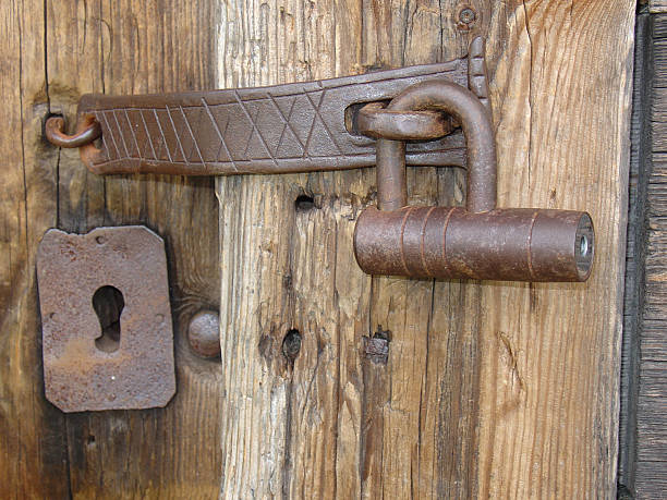 Iron padlock on an old peasant house stock photo