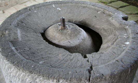 Old millstone in the windmill in the Netherlands