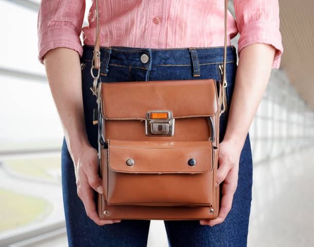 istock Young woman in deep blue jeans holding a bag 906875364