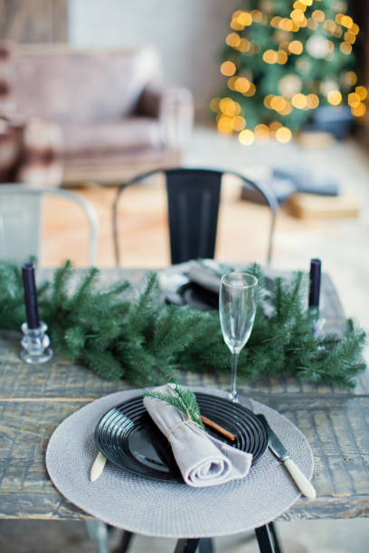 istock Rustic Christmas served table with vintage silverware, candles and fir twigs 906875430