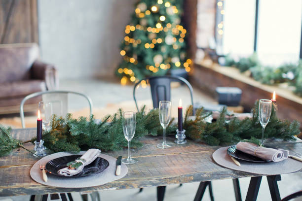 istock Rustic Christmas served table with vintage silverware, candles and fir twigs 906875590