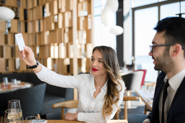 istock Woman calling waiter to pay for lunch 906876150
