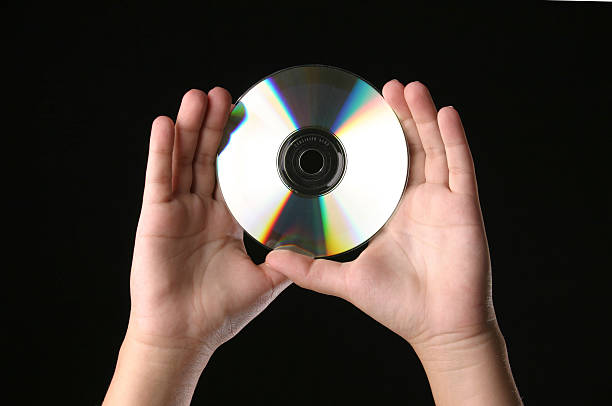 Hands holding a cd stock photo