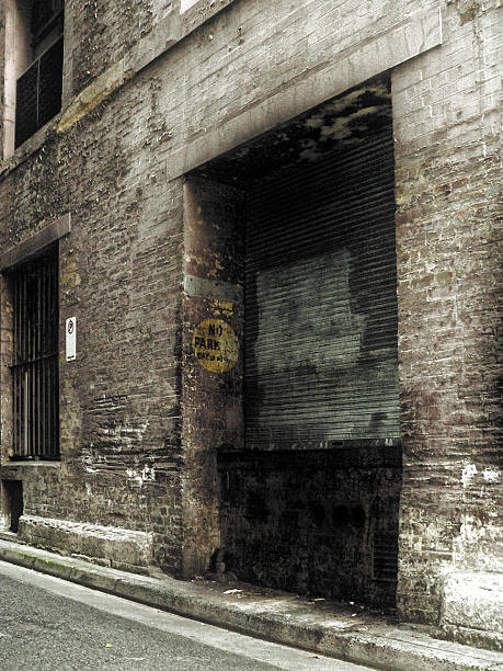 Old Industrial Shutter door in dark alley with grunge effect  seedy alley stock pictures, royalty-free photos & images