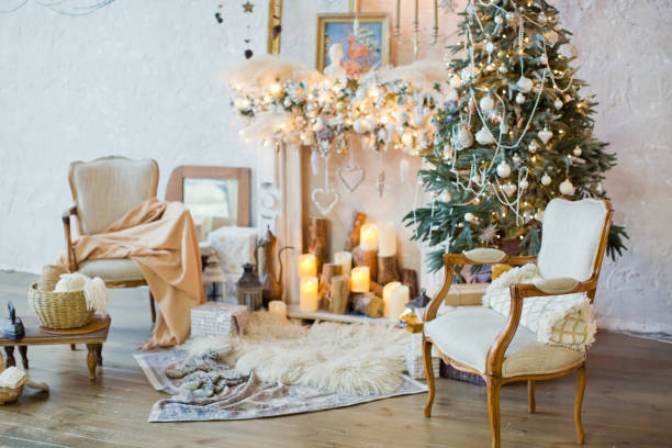 istock Christmas tree, chairs and vintage decorations near fireplace 906882964
