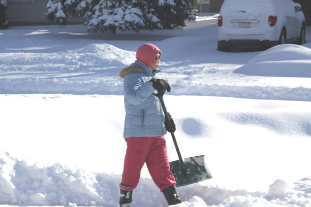 istock Lady Shoveling Snow in Driveway 906893254