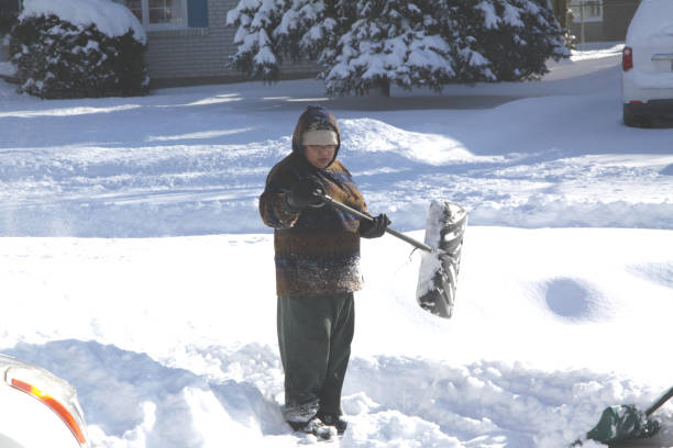 istock Lady Shoveling Snow in Driveway 906893272
