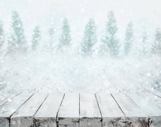 istock White wood table top on blurred snowfall in winter season 906893390