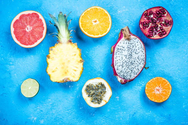 istock Tropical and exotic fruits halves on vibrant slate 906894474