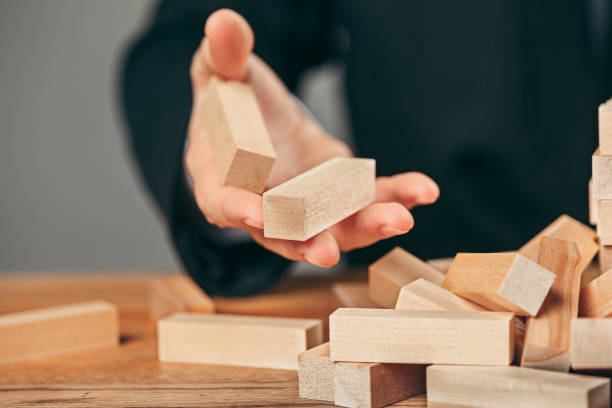 istock Man and wooden cubes on table. Management concept 906902758