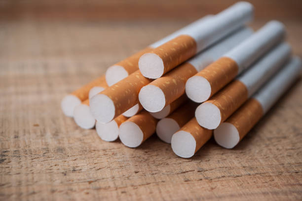 istock cigarette on wooden background 906910060