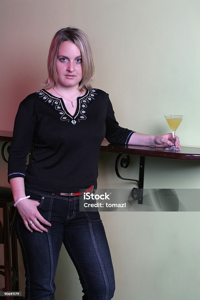 Cocktail and provocative pose Confident girl in a night club. Adult Stock Photo