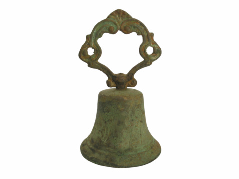The weathered church bell stands as a symbol of history and tradition, evoking a sense of reverence in its surroundings