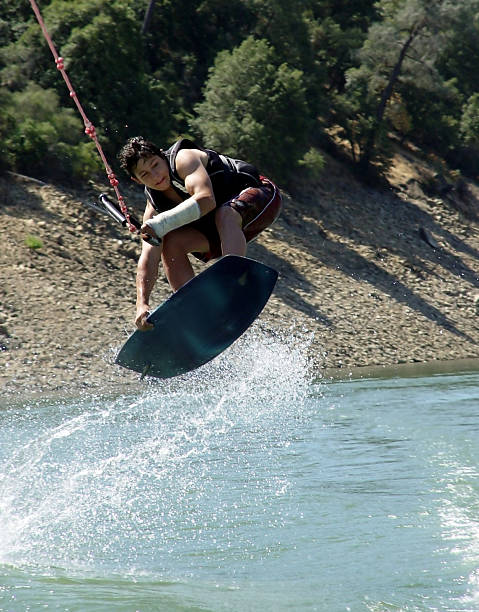 volare basso - life jacket little boys lake jumping foto e immagini stock